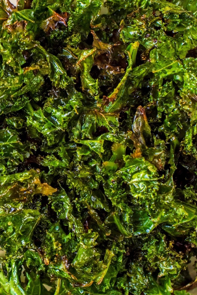 Crispy cooked leaves of kale with a coating of oil.