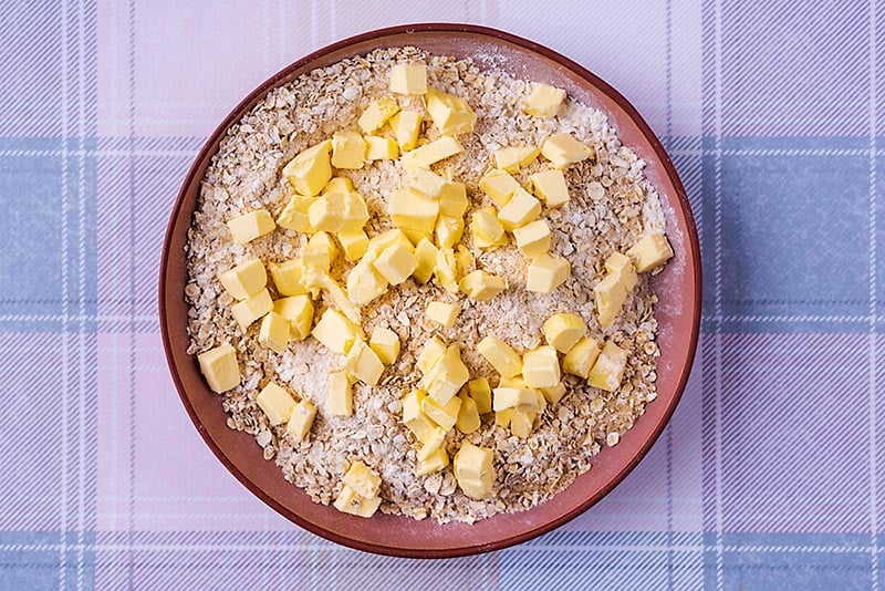 Oats, sugar and flour mixed together with cubes of butter