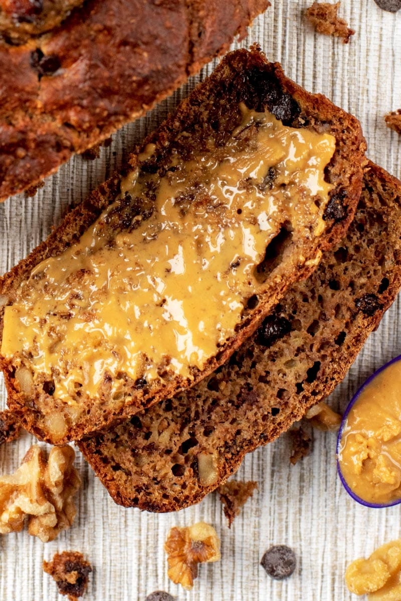 A slice of Banana Bread spread with peanut butter.