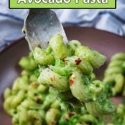 Creamy avocado pasta with a text overlay title.