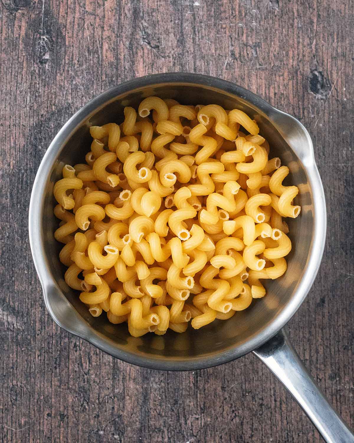 A silver saucepan full of spirali pasta.