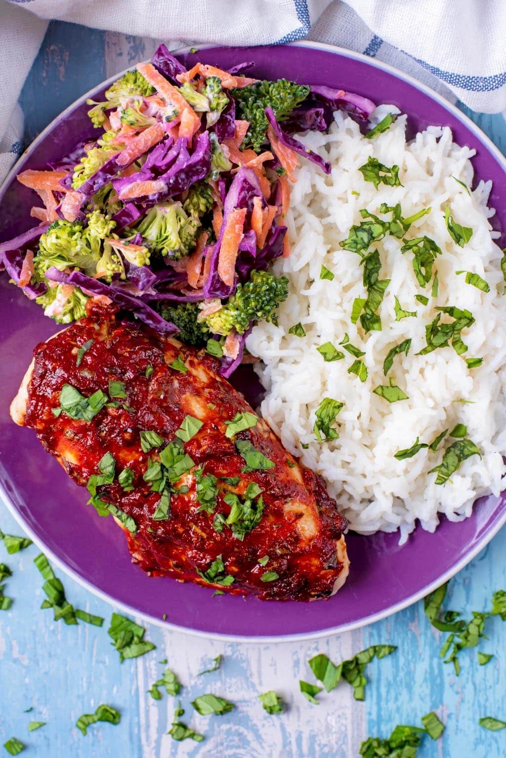 A plate of chicken, rice and slaw.