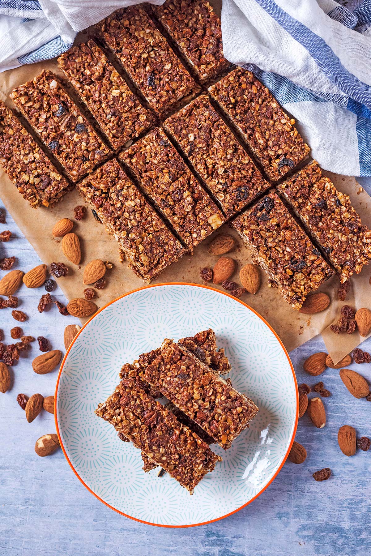 Rows of granola bars next to a plate with more bars on it,