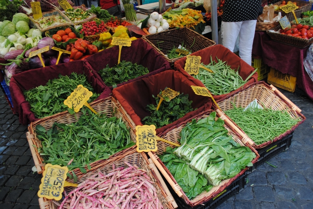 Baskets full of fresh vegetables at an outdoor market.