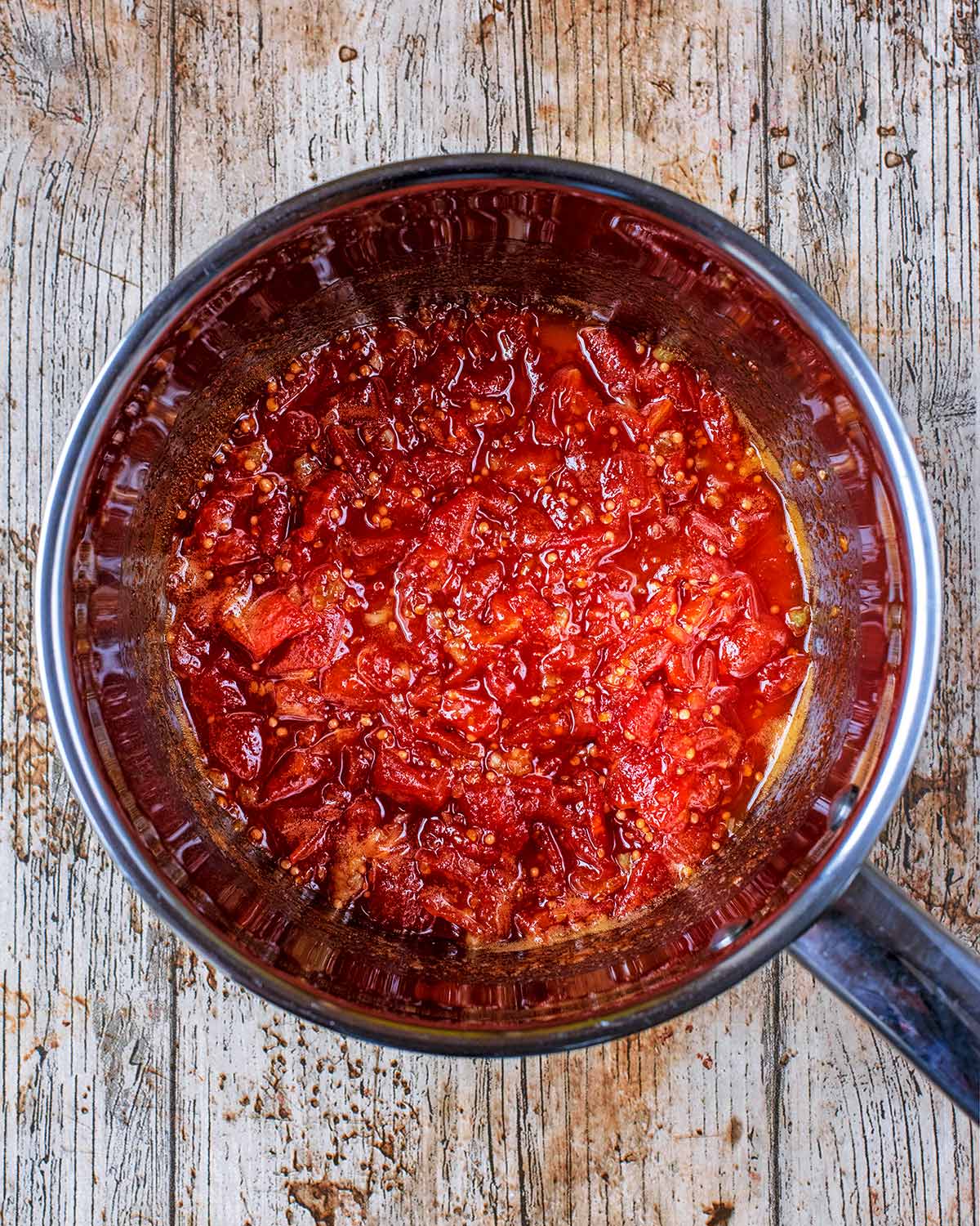 A saucepan containing cooked jam.