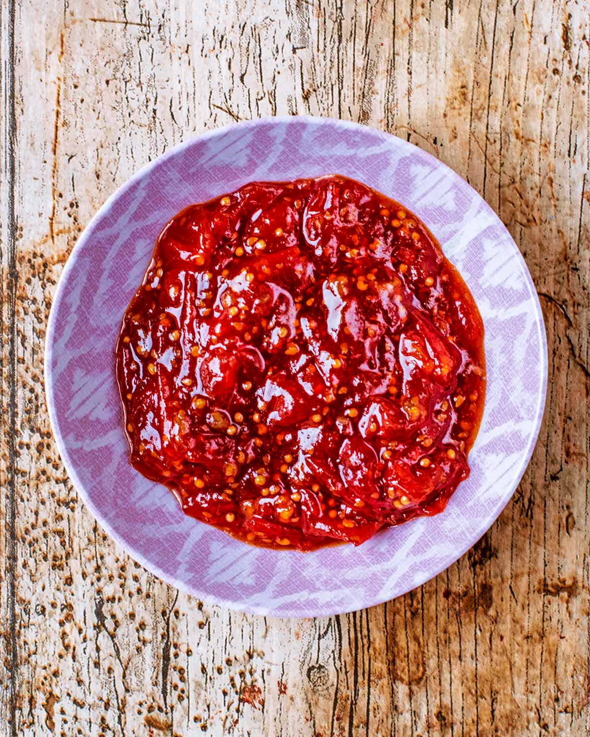 A small pink bowl containing chilli jam.