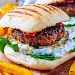 Spiced Lamb Burger on a serving board with fries.