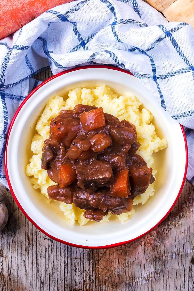 Beef casserole on top of mashed potatoes.