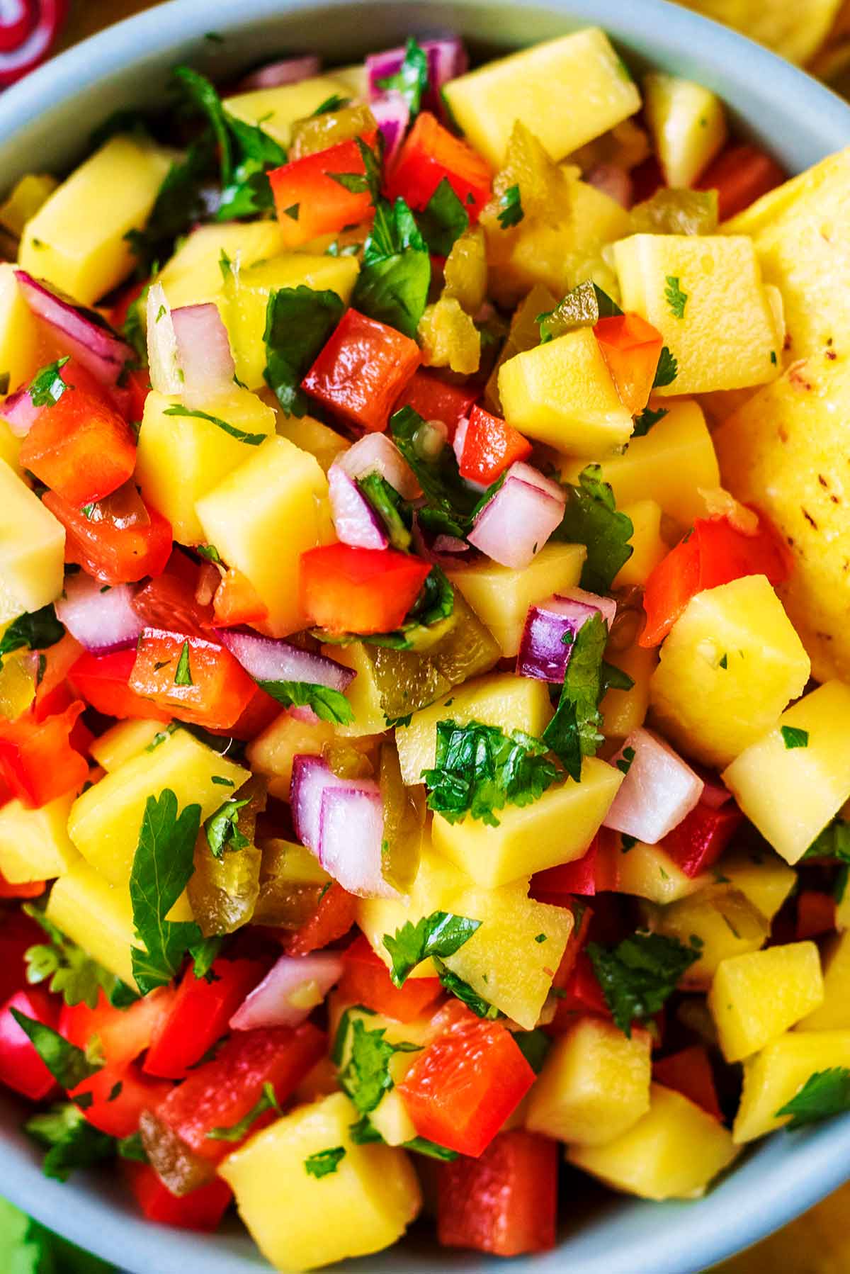 Chopped mango, tomatoes and onion mixed with coriander leaves.