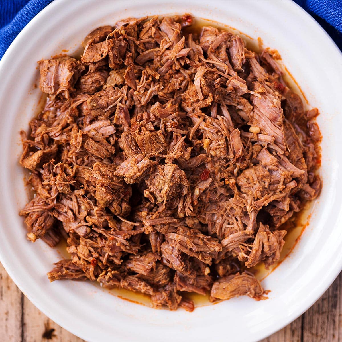 Slow Cooker Pulled Beef in a white bowl