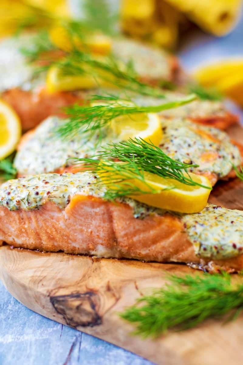 Cooked salmon fillets on a wood board.