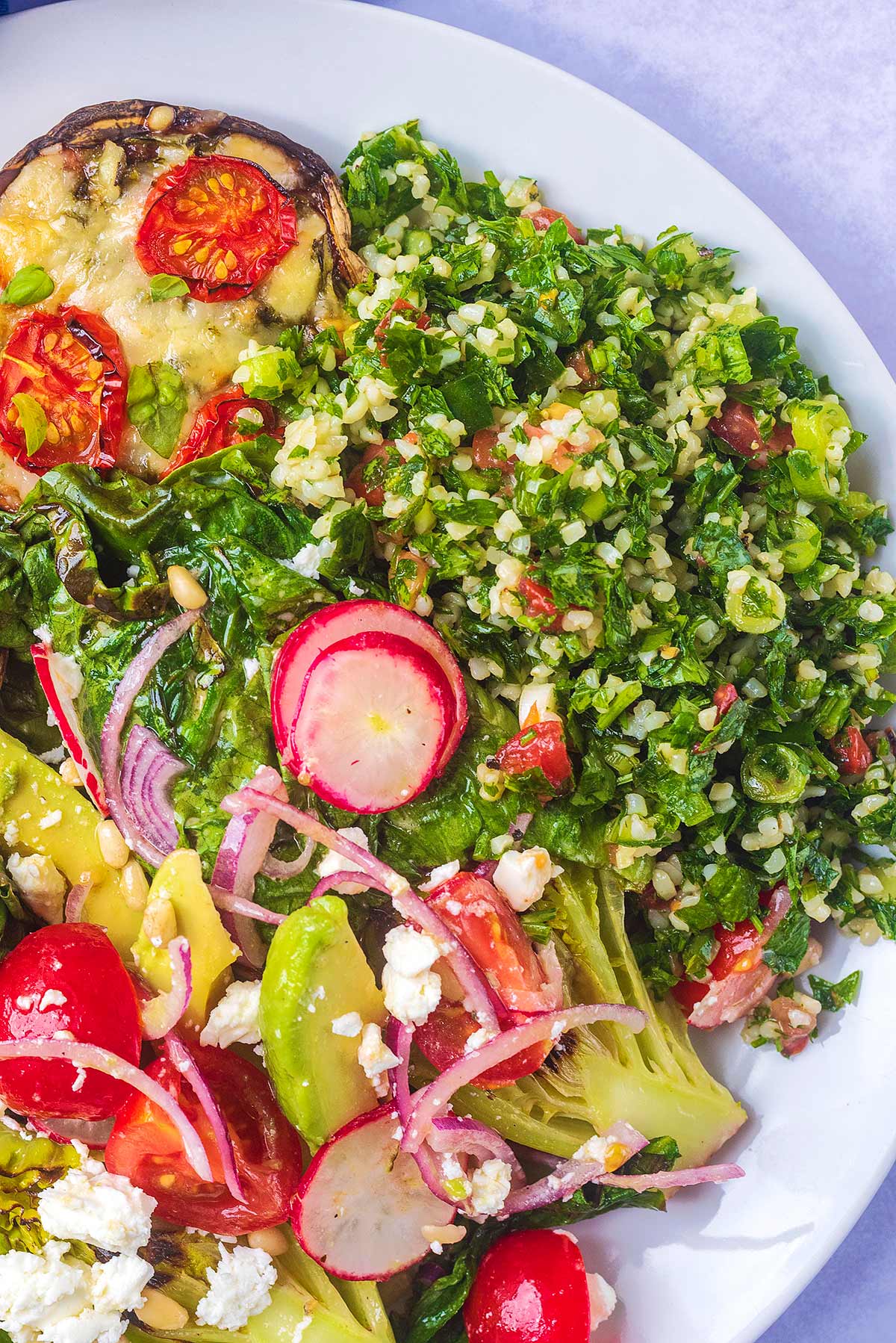 A plate of tabbouleh, salad and mushroom.