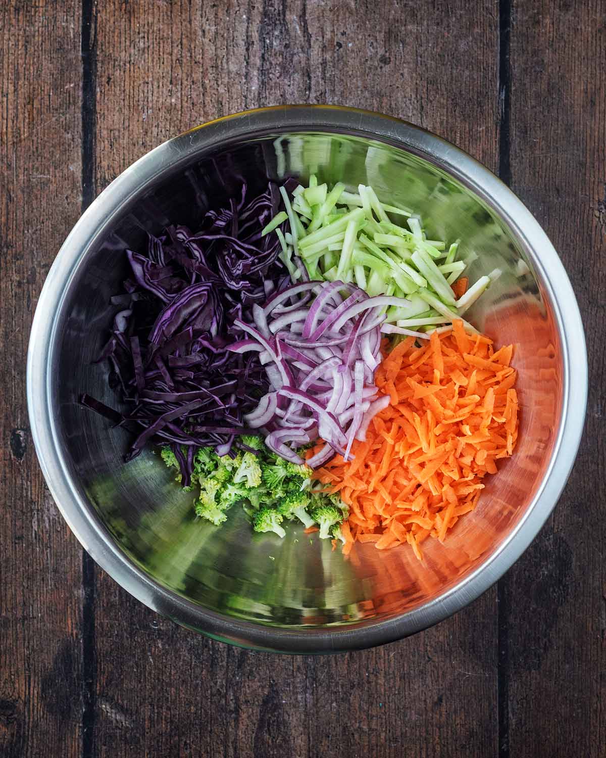 Shredded vegetables in a large mixing bowl.
