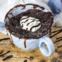 Healthy chocolate mug cake in front of a towel
