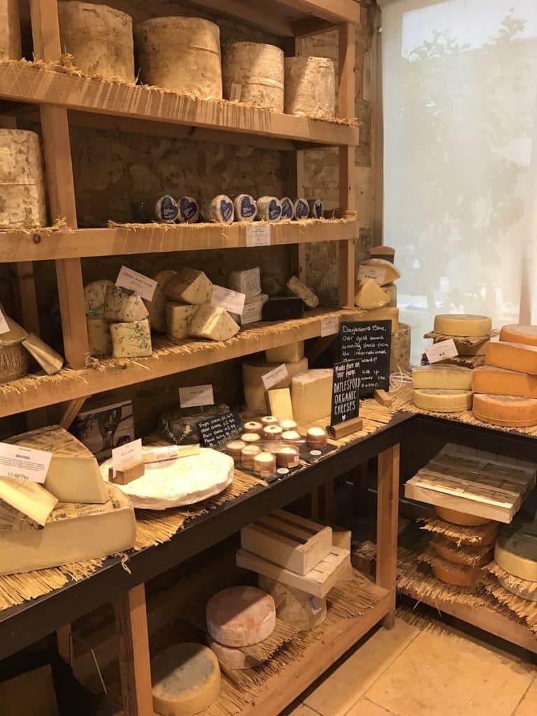 A chiller room with cheese on wooden shelves