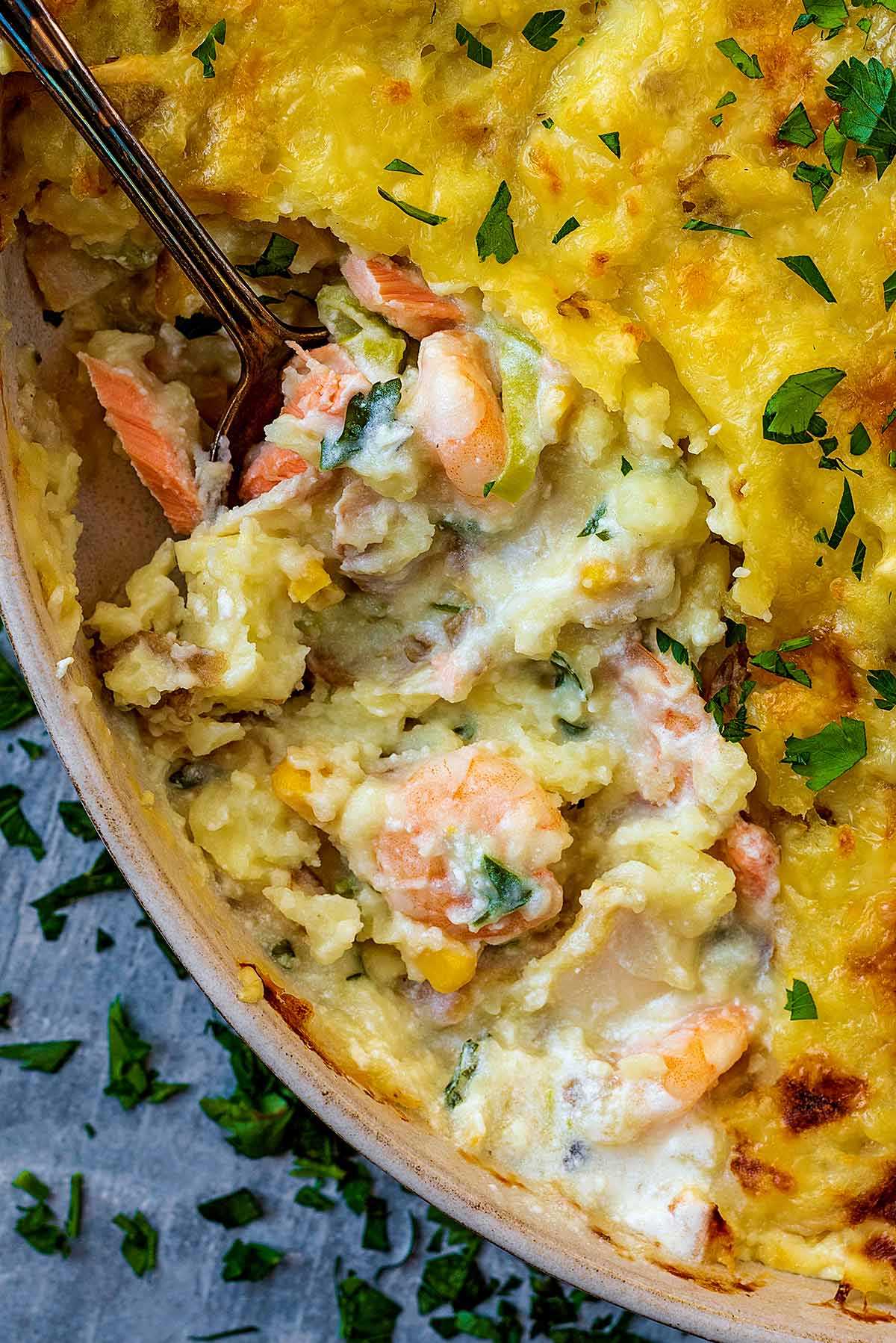 Prawns and flaked fish in a creamy sauce under a mashed potato top.