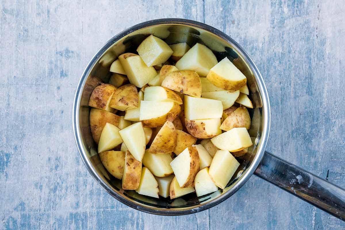 A saucepan full of chopped potatoes.