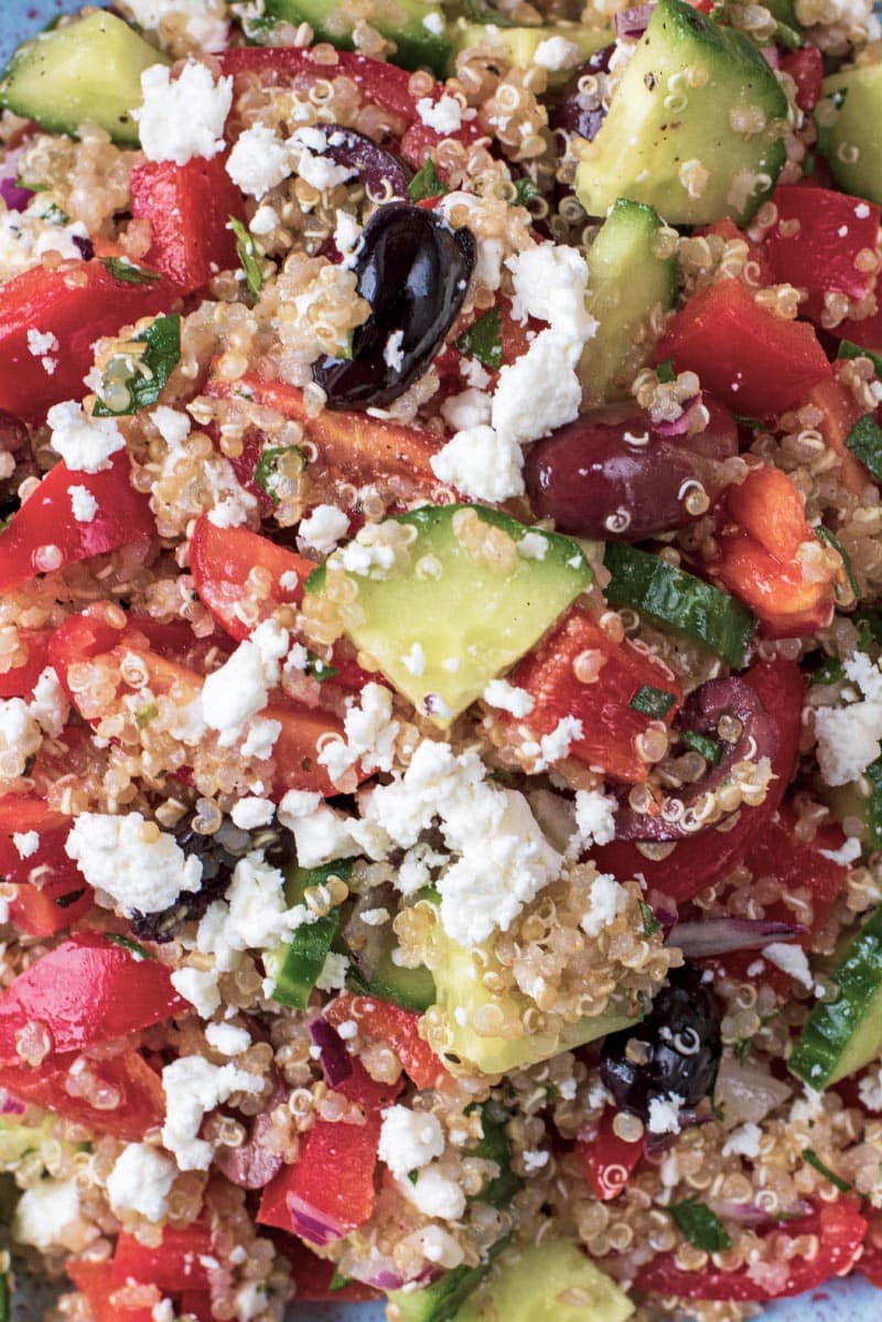 A salad made of quinoa, cucumber, tomato, olives and feta cheese.