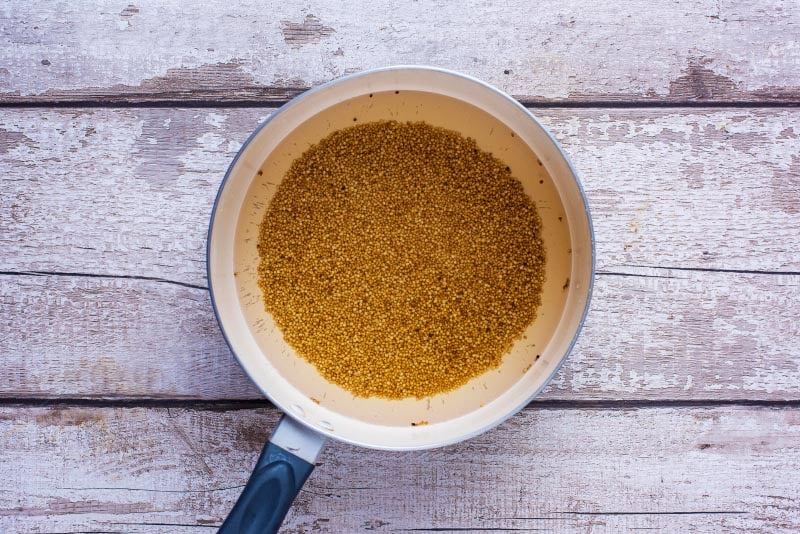 A saucepan containing cooked quinoa.