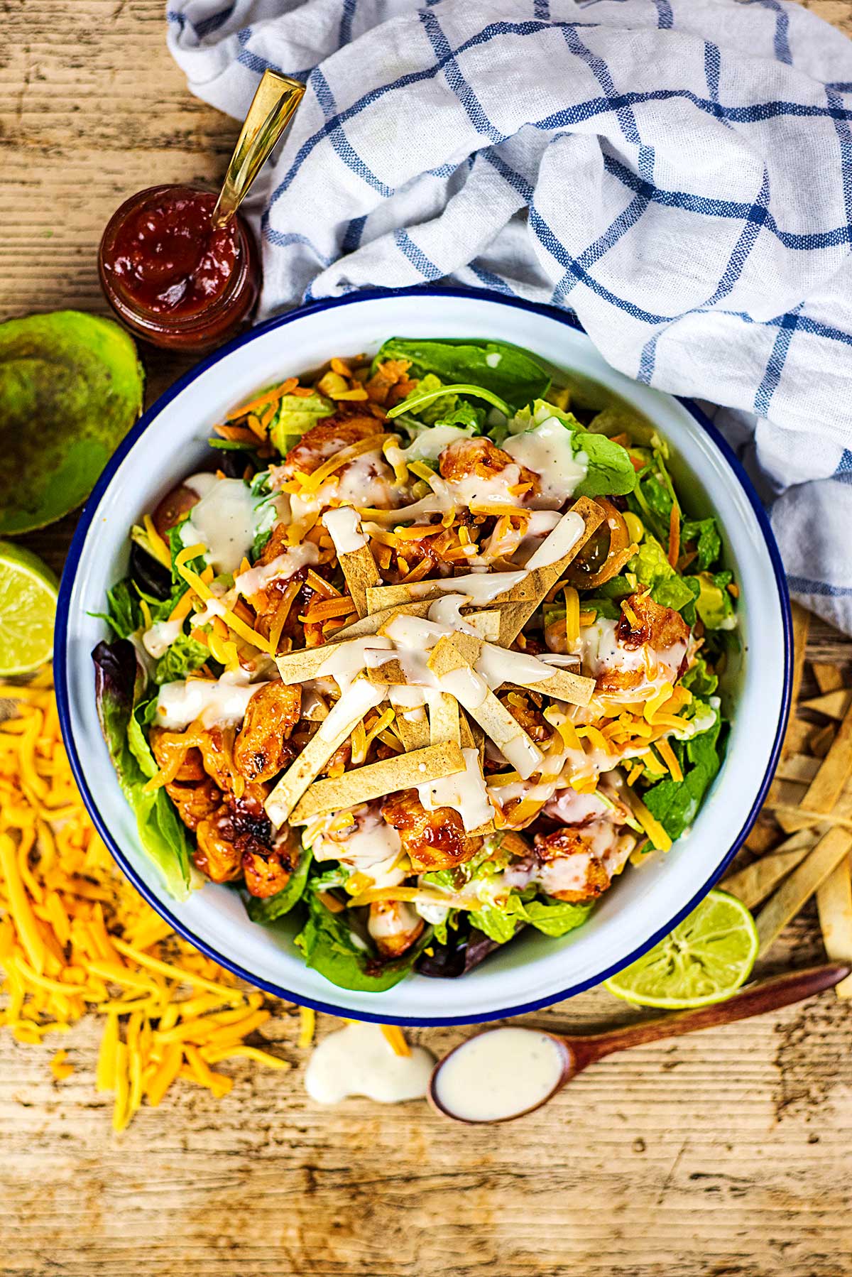 A bowl of chicken salad topped with tortilla strips.