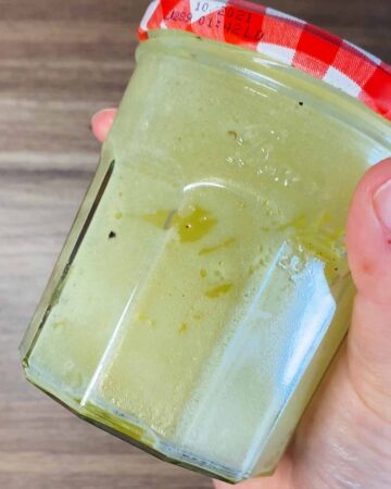 The vinaigrette shaken together in a sealed jar.