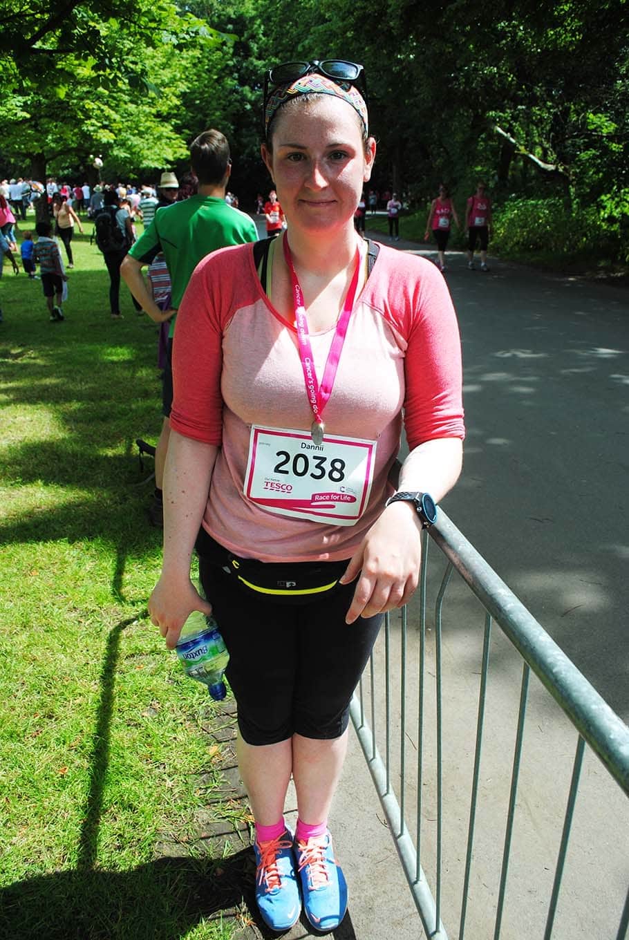 Woman standing by a barrier at Manchester's Race for Life.