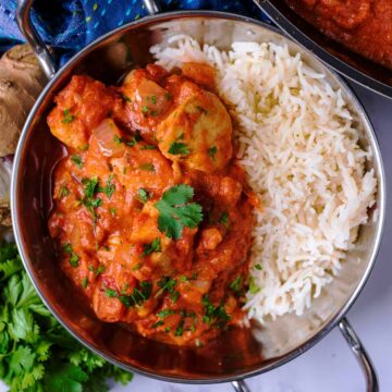 Murgh Makhani Butter Chicken in a metal dish with white rice.