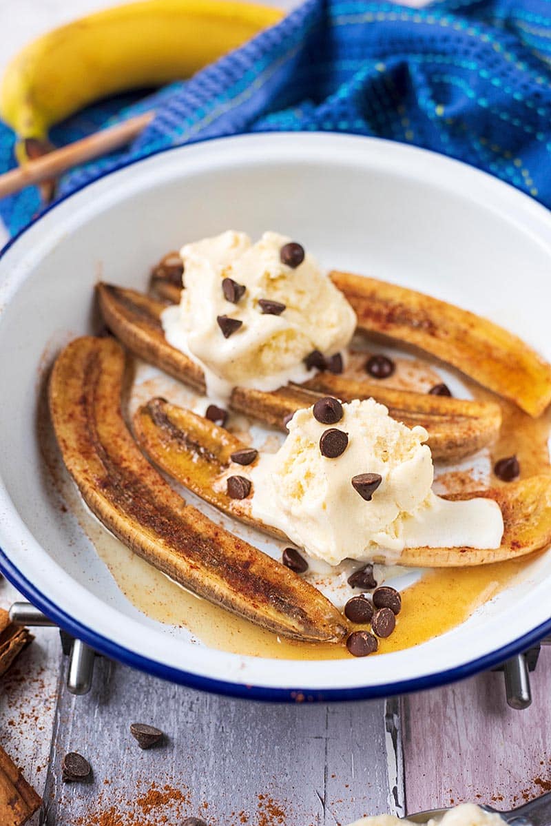 Baked Bananas in a dish topped with ice cream.