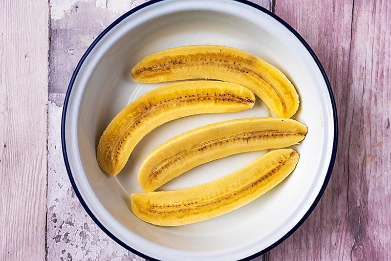 Four banana halves in a round dish