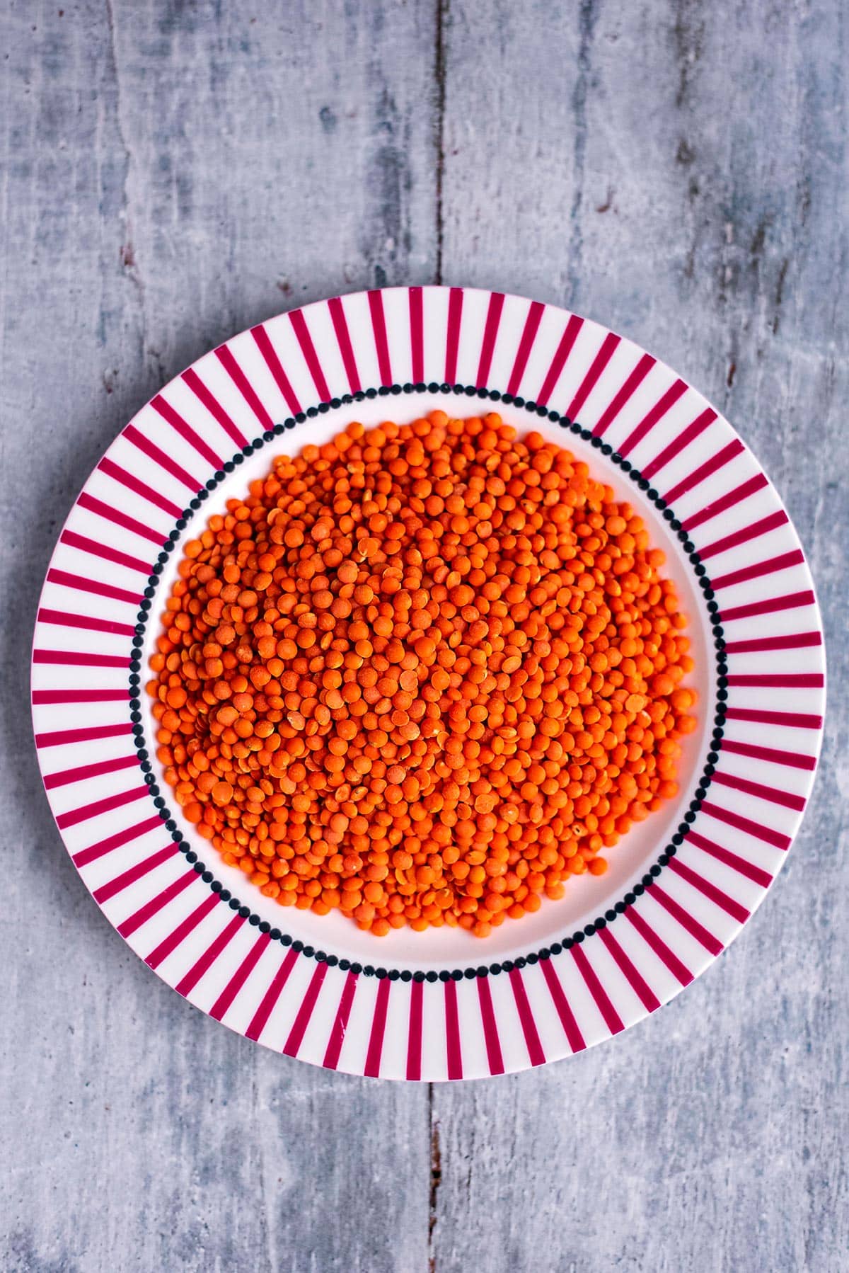 A large pile of red lentils on a plate.
