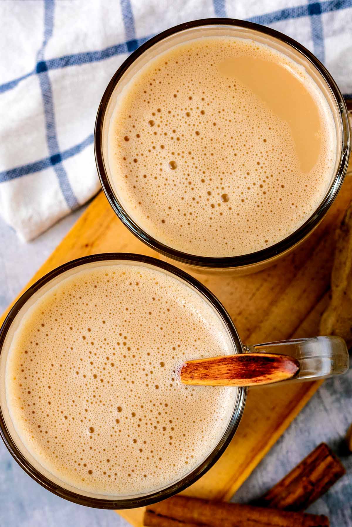 Two glasses of chai tea latte viewed from above.