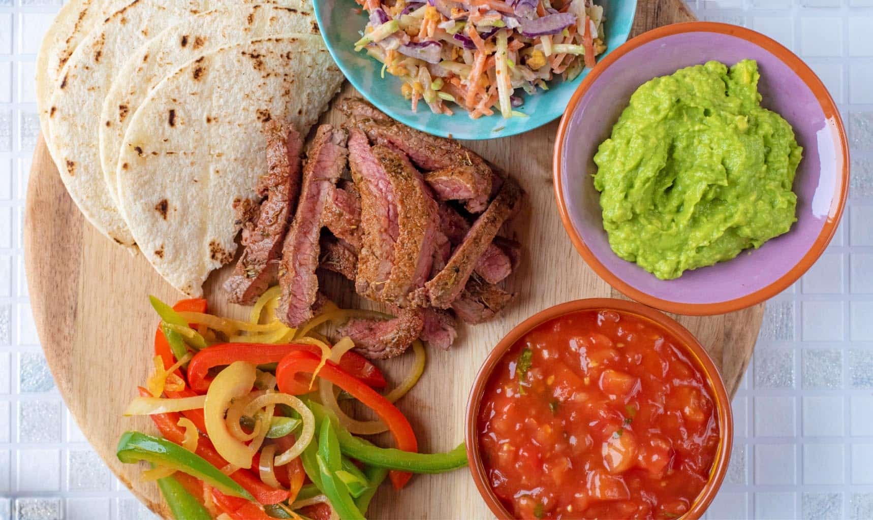 deconstructed Cajun Steak Tacos on a round serving board