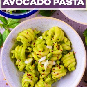 Creamy avocado pasta in a bowl with a text title overlay.