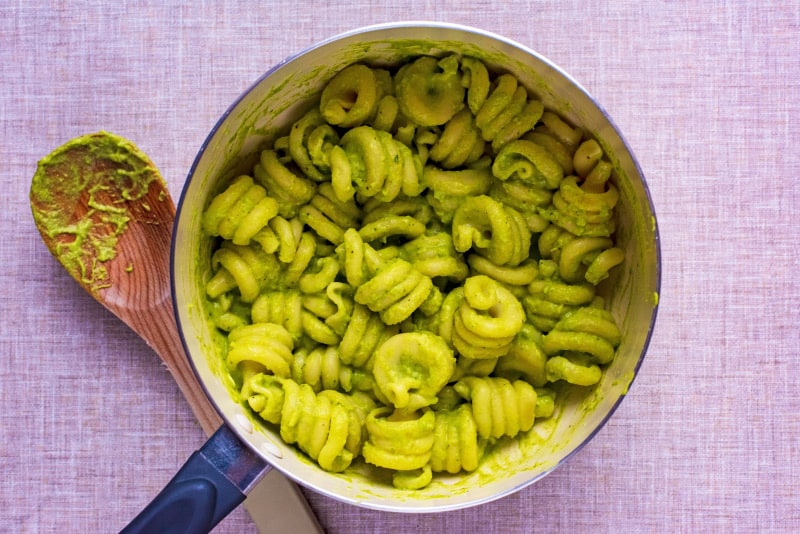 A saucepan of cooked pasta in an avocado sauce.