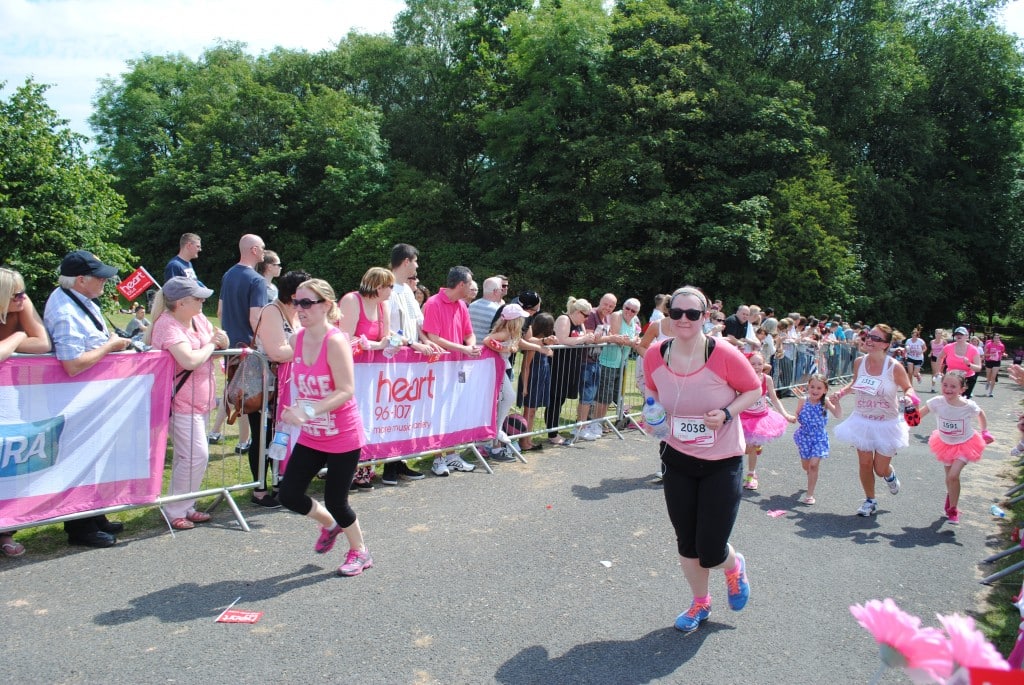 competitors dressed in pink running in the race for life.