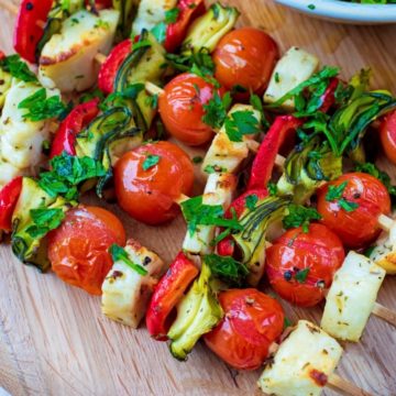 Vegetable and Halloumi Kebabs on a circular chopping board