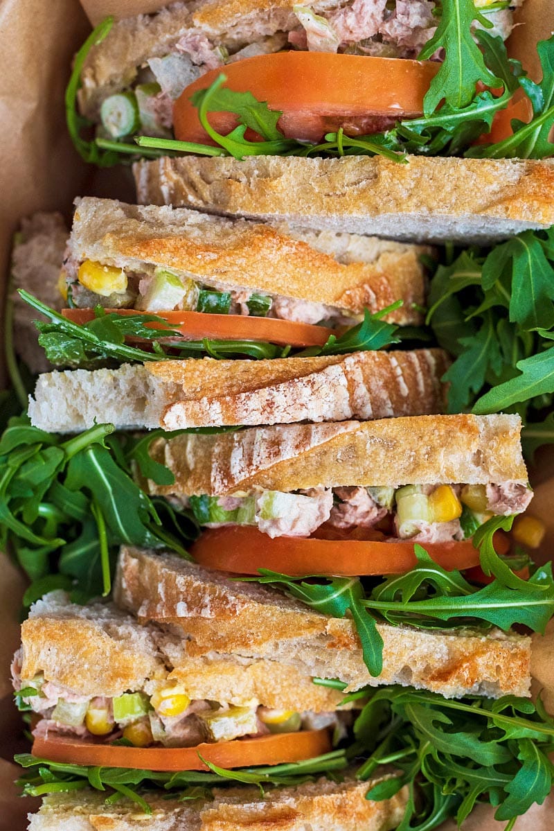 Tuna sandwiches stood up in a row.