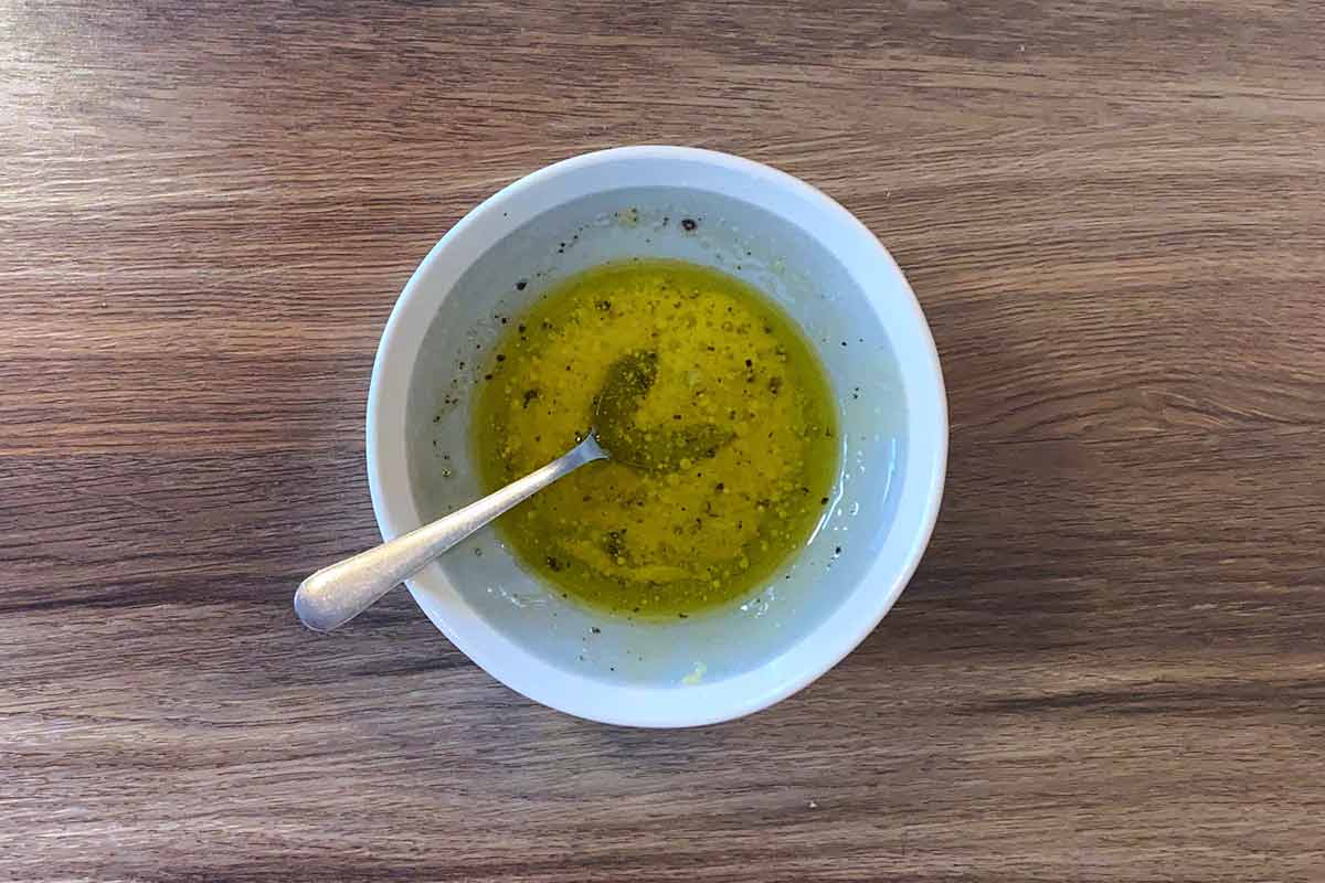 A small bowl containing a salad dressing.