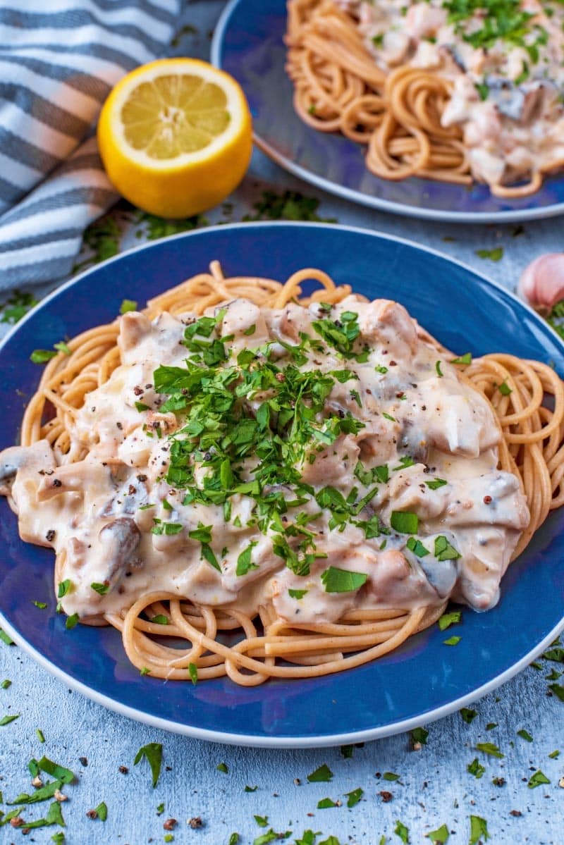 Spaghetti topped with a creamy mushroom sauce topped with chopped parsley.