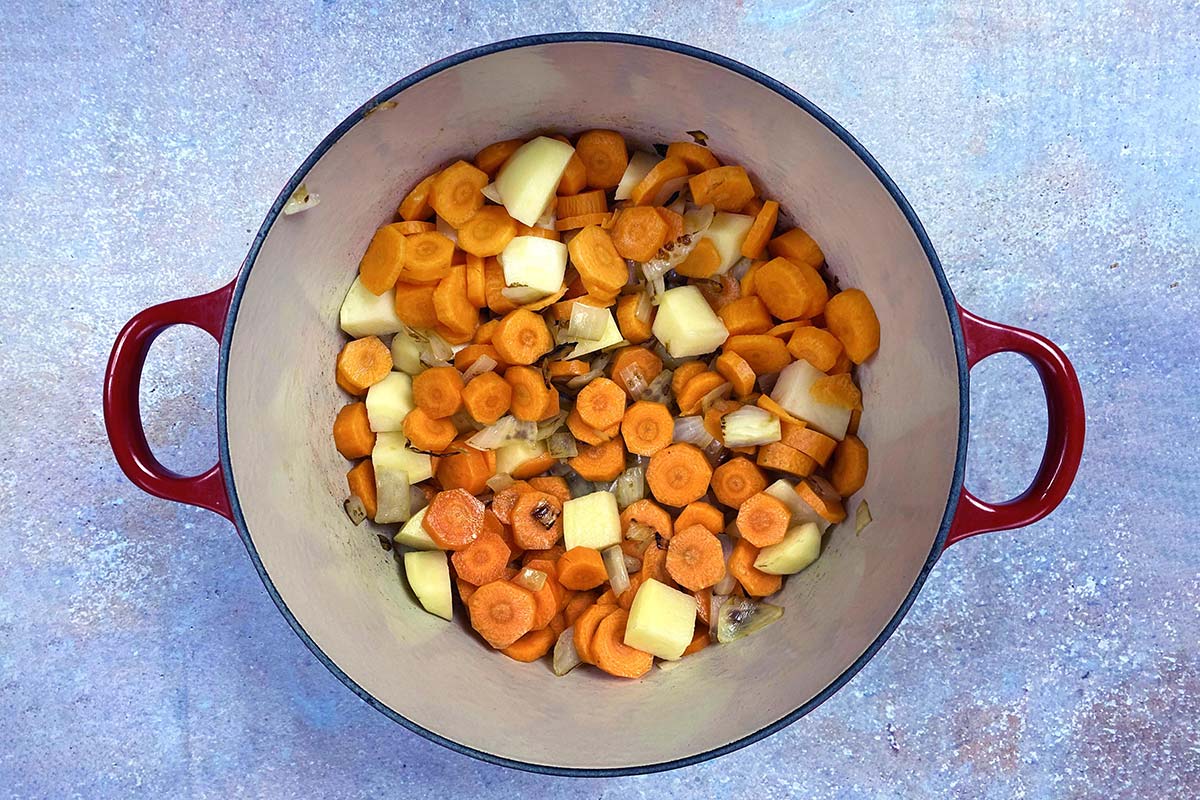 Chopped carrots and potato added to the pan.