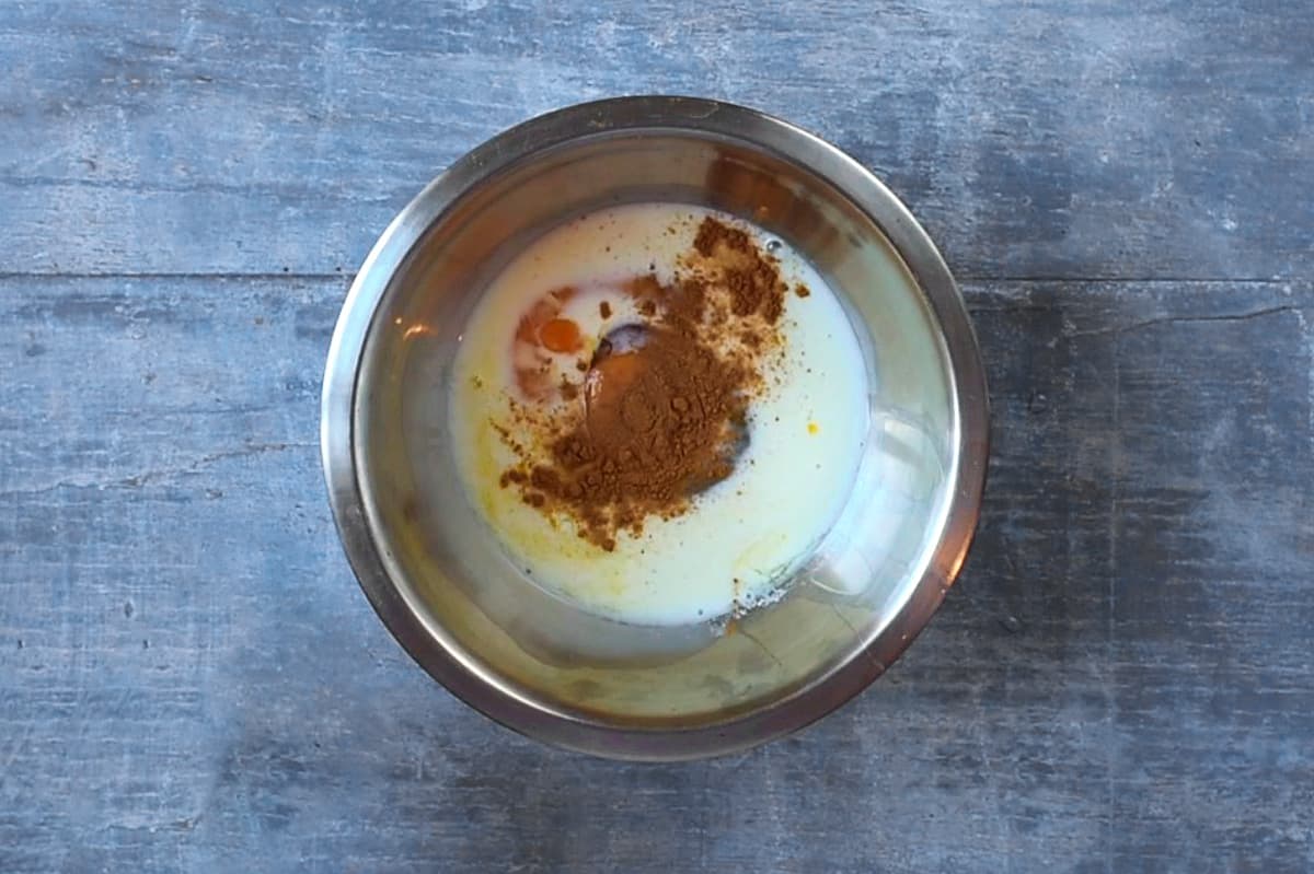 Eggs, milk and spices in a mixing bowl