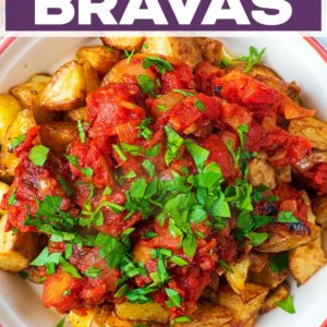 A bowl of patatas bravas with a text title overlay.
