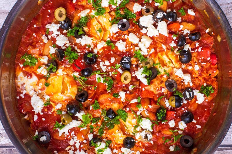 Shakshuka topped with feta, olives and herbs.