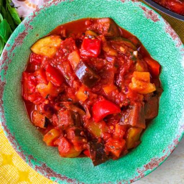 Vegetable ratatouille in a green bowl.