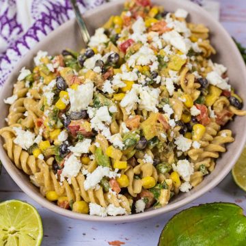 Mexican Pasta Salad in a bowl with crumbled feta on top.