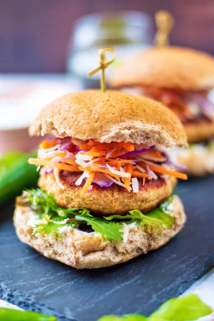 Salmon burger in a bun with lettuce and slaw