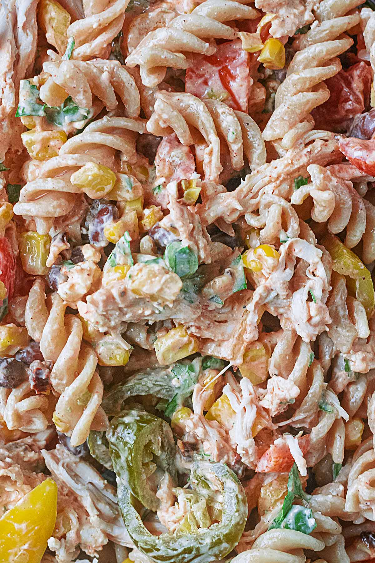 Cooked pasta, shredded chicken and chopped salad vegetables all coated in a creamy dressing.