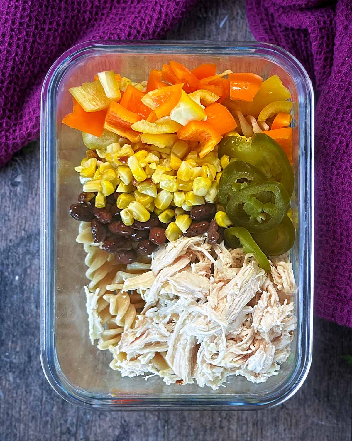 Peppers, jalapenos, corn and beans added to the container.