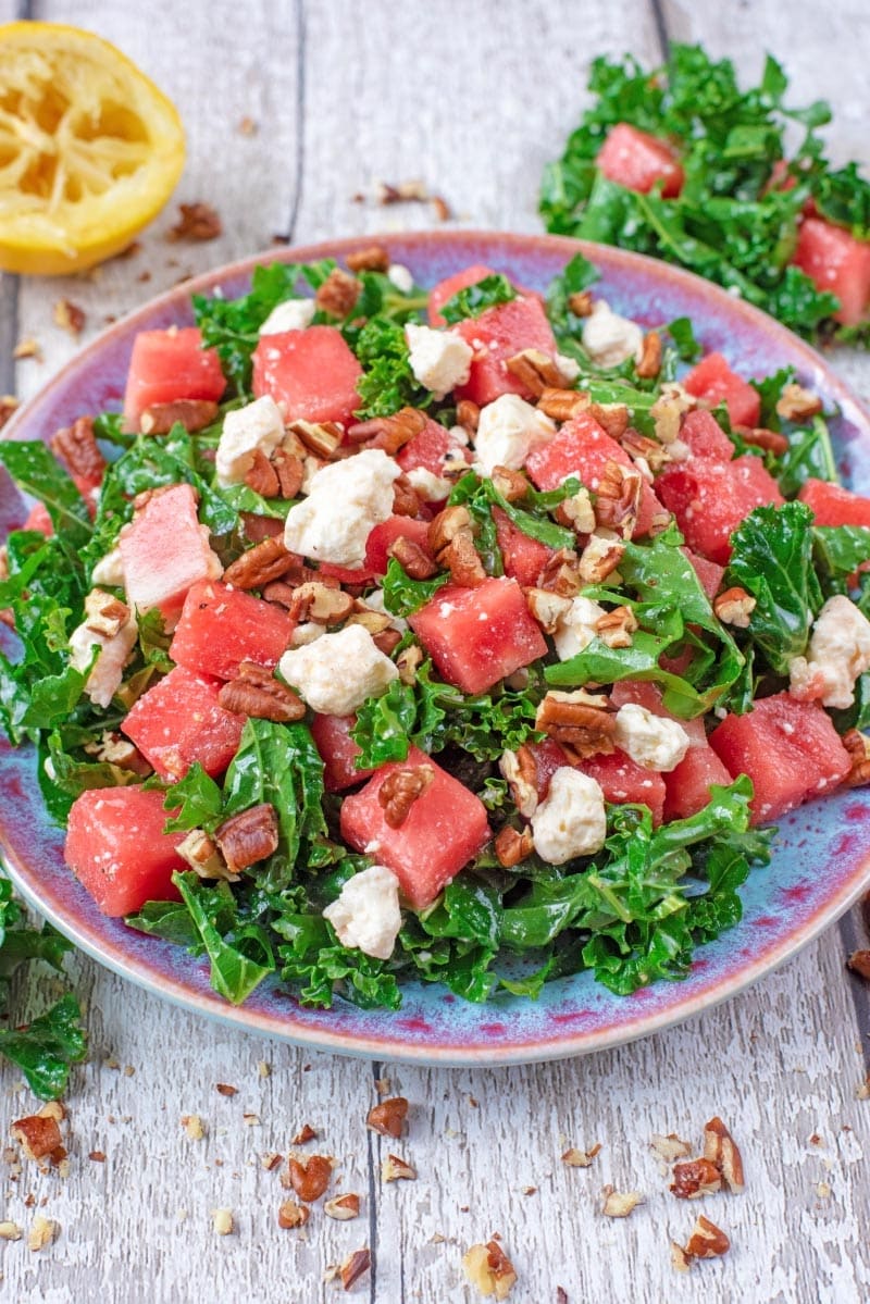 A blue plate with Kale, Feta and Watermelon Salad.