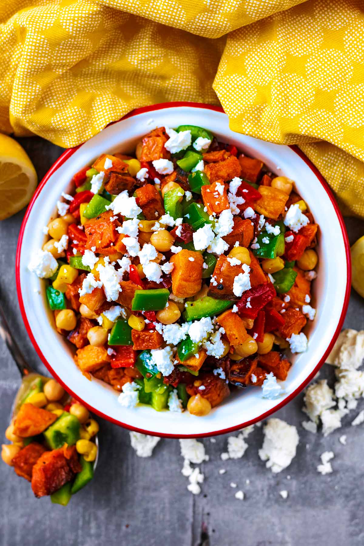 A bowl of sweet potato salad next to a yellow towel